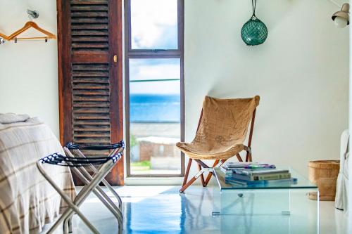 a living room with a chair and a glass table at Sea Castle's Paternoster in Paternoster