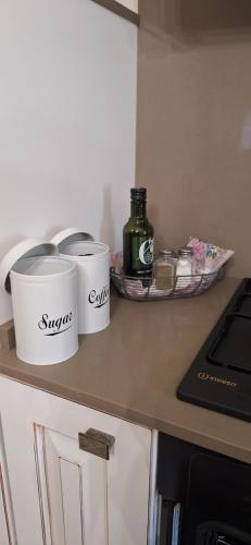 a kitchen counter with two cups on a counter top at Lajatico Rentals -Grotticella House, SPA Apartment in Peccioli in Peccioli