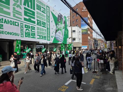 a crowd of people crossing a street in a city at Forest Hangang in Seoul