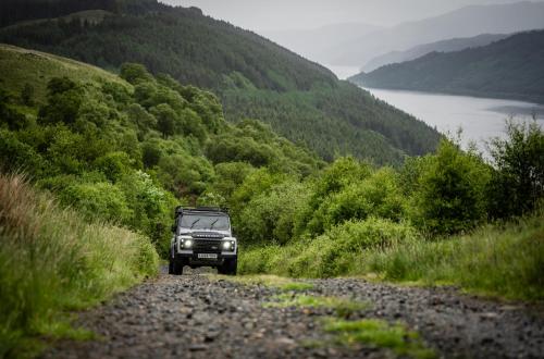 a jeep driving down a dirt road on a hill at JA Mar Hall Scotland in Bishopton