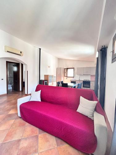 a red couch sitting in a living room at Lucia Home in Tortolì
