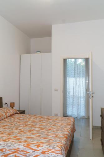 a bedroom with a bed and a large window at Boulevard Holiday in Avola
