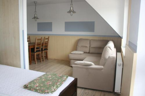 a living room with a couch and a table at Kantal Apartamenty Hel in Hel