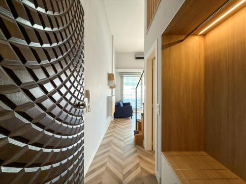a hallway with a wall of wood at Luxury Downtown Apartment With Seaview E2 in Thessaloniki