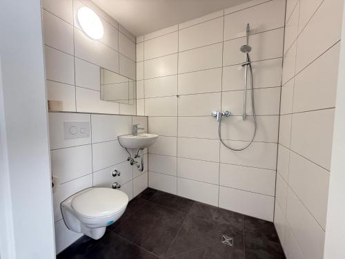 a white bathroom with a toilet and a shower at Neu 2025 Apartment mit Bad und Küche zwischen Köln und Bonn in Wesseling