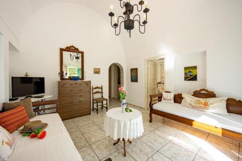 a large living room with a bed and a table at Amoni House- An authentic village stay in Pyrgos