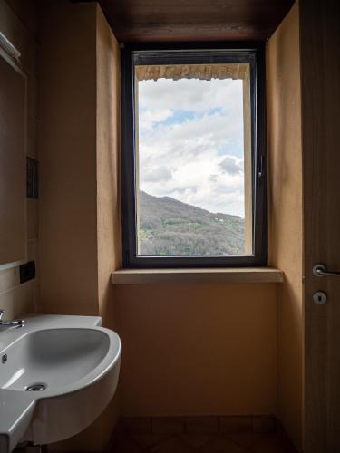 a bathroom with a sink and a window at Convento Francescano Experience Hotel Cilento in Cuccaro Vetere