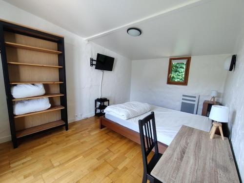 une chambre avec un lit, une table et une télévision dans l'établissement Maison Plein Sud St Lunaire Bretagne, à Saint-Lunaire