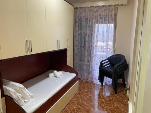 a small room with a bed and a chair at Milaj Apartment in Orikum