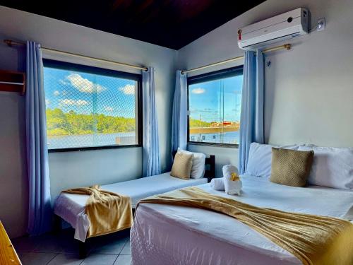 Katil atau katil-katil dalam bilik di Lar da Preguiça: 90m2,Vista incrível, A/C, Wi-Fi, à 700m do centro.