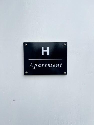 a sign on a wall that says h apartment at Eiðar - Apartments in Eiðar