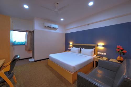 a hotel room with a bed and a couch at TreeHouse Morina, Vithalapur in Vithalpur
