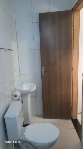 a bathroom with a toilet and a sink at Village Sapiranga in Mata de Sao Joao