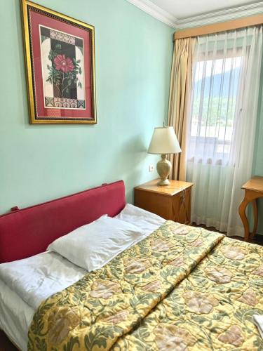 a bedroom with a bed and a picture on the wall at Hotel Lileo in Mestia