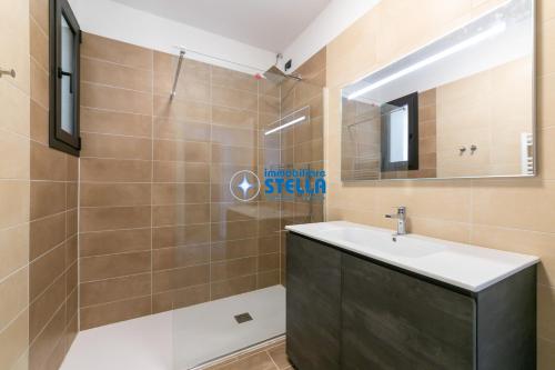 a bathroom with a sink and a shower with a mirror at Caribe Village in Lido di Jesolo