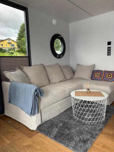a living room with a couch and a table at Houseboat -La Calma- Czaplinek in Czaplinek