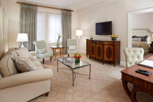 a living room with a couch and a television in a hotel room at The Pierre, A Taj Hotel, New York in New York