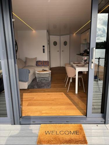 a view of a room with a couch and a table at Houseboat -La Calma- Czaplinek in Czaplinek