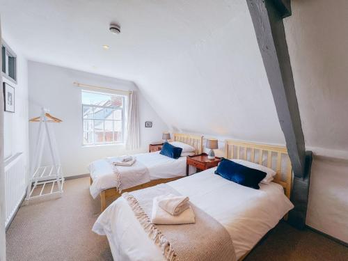 a room with two beds and a window at Route 2 Apartments in Topsham