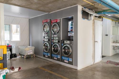 a room with three washing machines in a wall at TJ 4711 Residence in Maha Sarakham