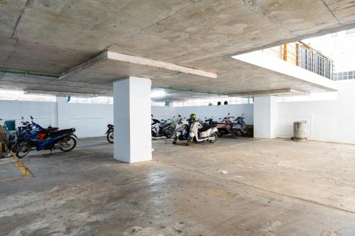 a group of motorcycles parked in a parking lot at TJ 4711 Residence in Maha Sarakham