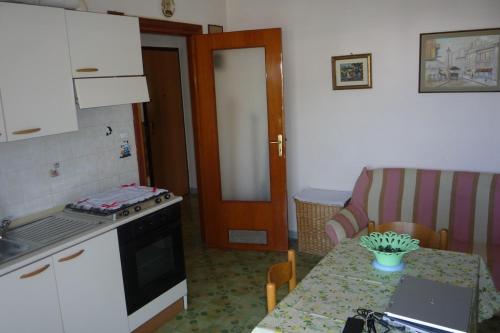 a kitchen with a table with a laptop on it at Villa Franca in Giovinazzo