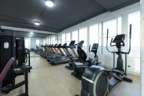 a gym with a row of treadmills and machines at TJ 4711 Residence in Maha Sarakham