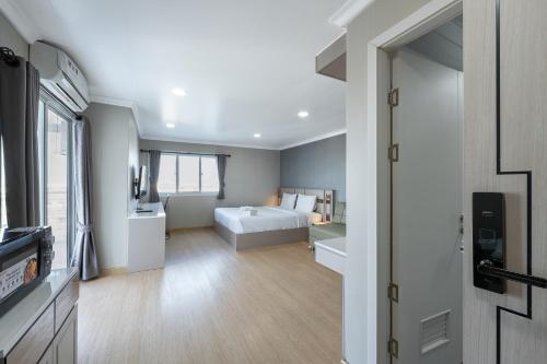 a large room with a bed and a television at TJ 4711 Residence in Maha Sarakham