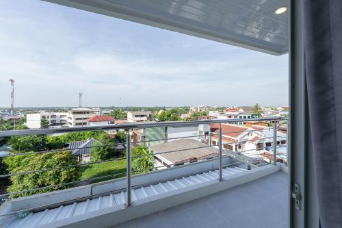 a balcony with a view of a city at TJ 4711 Residence in Maha Sarakham