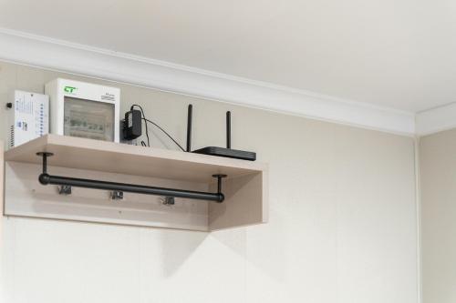 a shelf with a phone on a wall at TJ 4711 Residence in Maha Sarakham