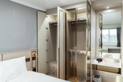 a bedroom with a bed and a glass closet at TJ 4711 Residence in Maha Sarakham
