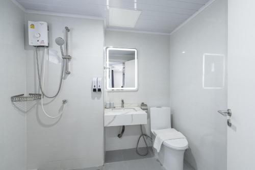 a white bathroom with a shower and a sink at TJ 4711 Residence in Maha Sarakham