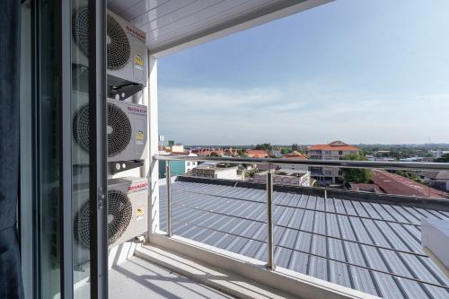 a balcony with a view of a city at TJ 4711 Residence in Maha Sarakham