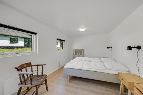 a bedroom with a bed and a desk and a chair at Lovely Holiday Home, Completely Renovated In 2025, In Quiet And Beautiful Surroundings in Sønder Felding
