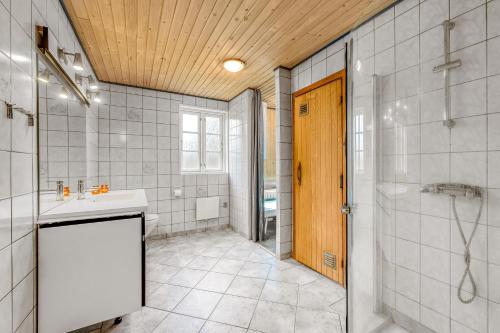 a bathroom with a shower and a sink and a shower at Large Holiday Home With Pool, Spa And Sauna, 1500 Meters From The North Sea in Ulfborg