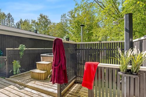 a deck with two red towels on a fence at Lovely Renovated Holiday Home With A Wilderness Bath And Fenced Grounds in Vesløs