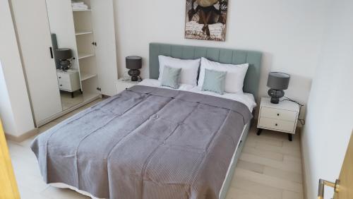 a bedroom with a large bed and a mirror at Wind Rose Montenegro in Igalo