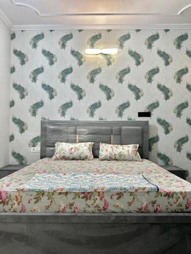 a bedroom with a bed with a floral bedspread at Mojo house jaipur in Jaipur