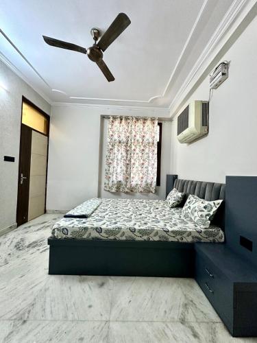 a bedroom with a bed and a ceiling fan at Mojo house jaipur in Jaipur