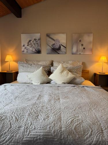 a bedroom with a large white bed with pillows at Sauerländer Henne-Lütt in Meschede