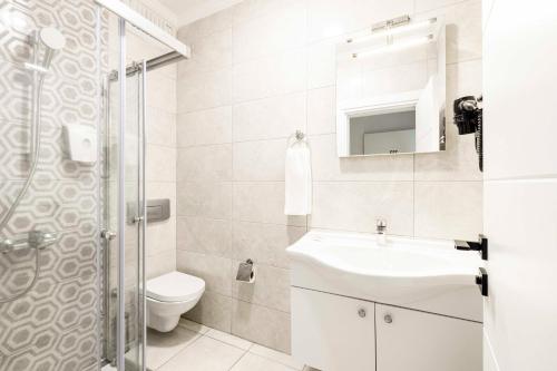 a bathroom with a sink and a toilet and a shower at Costa Maya Bodrum in Bodrum City