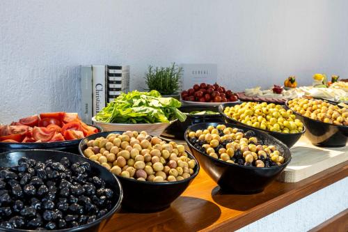 a table with bowls of different fruits and vegetables at Costa Maya Bodrum in Bodrum City