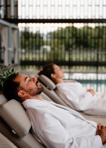 two people laying in beds in a hospital at Tasman Holiday Parks - Rotorua in Rotorua