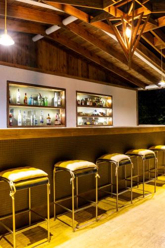 a row of stools in a bar with wooden ceilings at Costa Maya Bodrum in Bodrum City