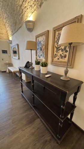a room with a table with two lamps on it at La Cummersa Trulli Holiday in Alberobello