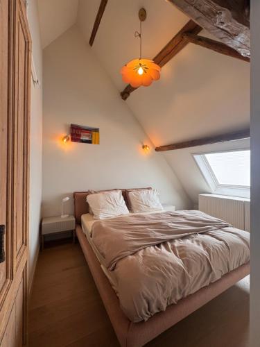 a bedroom with a large bed in a attic at Slapen in de Paardenstraat in Zierikzee