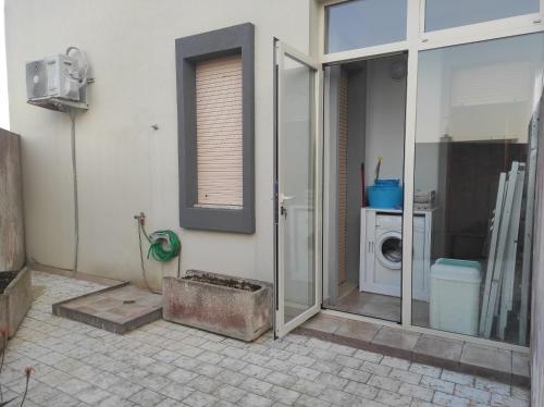 a bathroom with a shower and a washing machine at Dimora Zoe sea view by CASASI Vacanze Otranto in Otranto