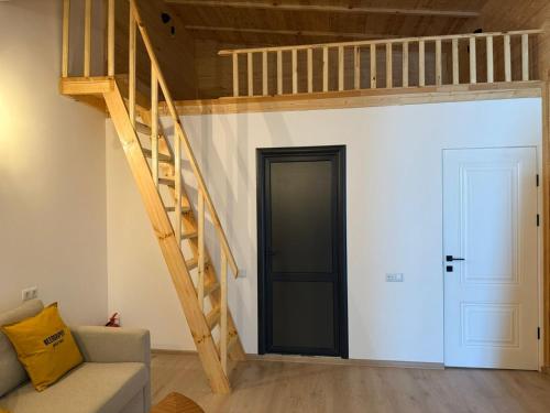 a living room with a loft bed and a staircase at Beeography guest house in Vardablur