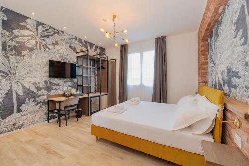 a hotel room with a bed and a desk at OPHELIA Hotel in Cazzago San Martino