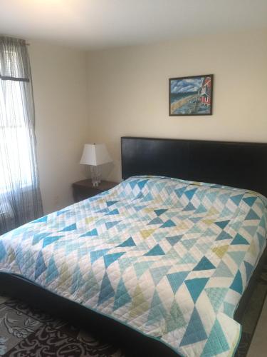 a bed with a quilt on it in a bedroom at Misquamicut Beach Front Inn in Misquamicut